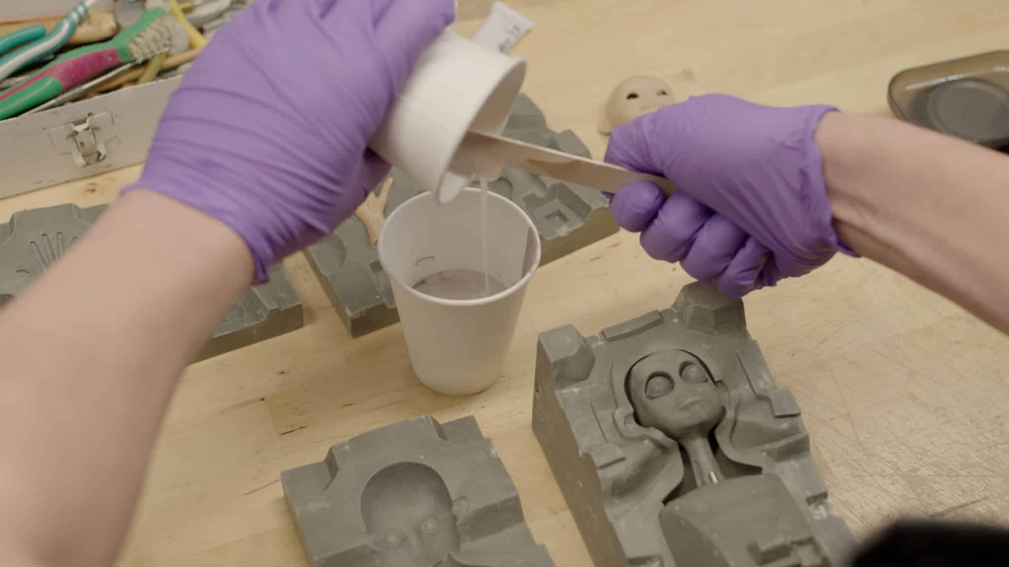ShadowMachine employee pouring resin in mold